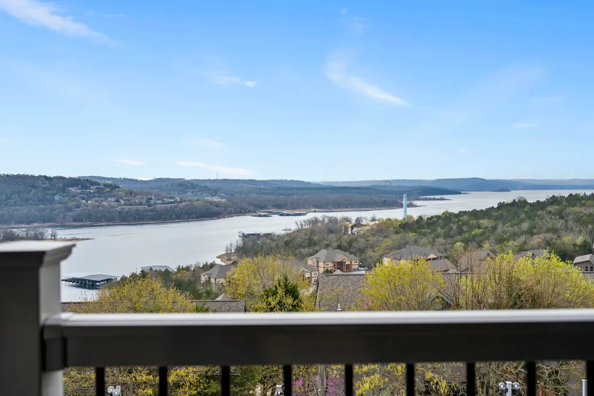 The hero image showcases a breathtaking panoramic view of Table Rock Lake, stretching out beyond gently rolling hills and dotted with tree-lined shores and lakeside homes. The tranquil water reflects the vibrant colors of a sunset sky, while hints of nearby nature activities—like boating and fishing—can be imagined from the serene scene.